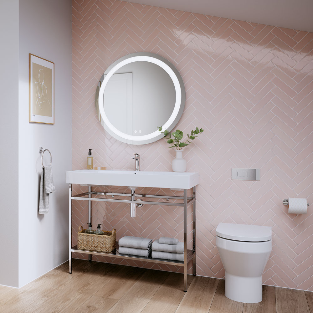 Chrome brassware incorporated with a pastel pink coloured bathroom