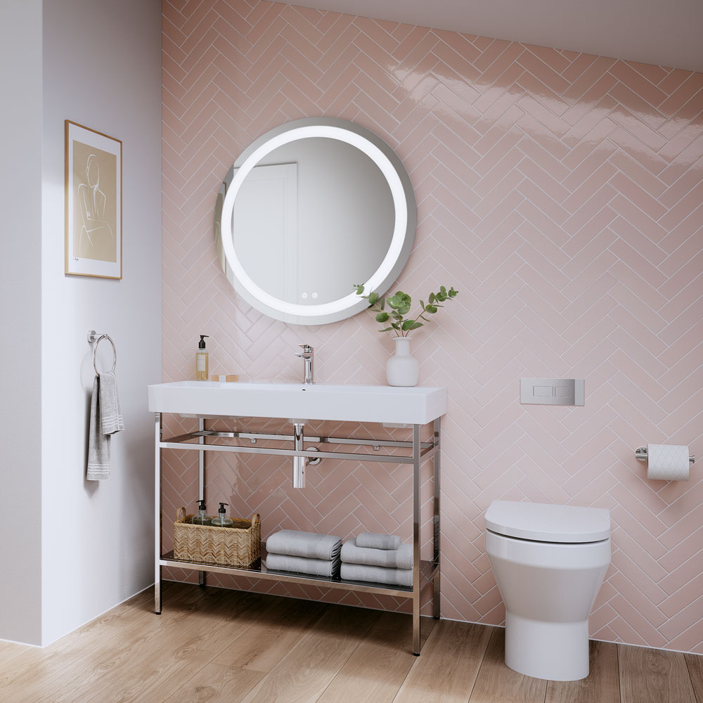 The bathroom shown here has pastel pink and white walls. The bathroom furniture and ceramics are white, creating a light bathroom design. To compliment these colours, chrome brassware has been used. Chrome brassware incorporated with a pastel pink coloured bathroom