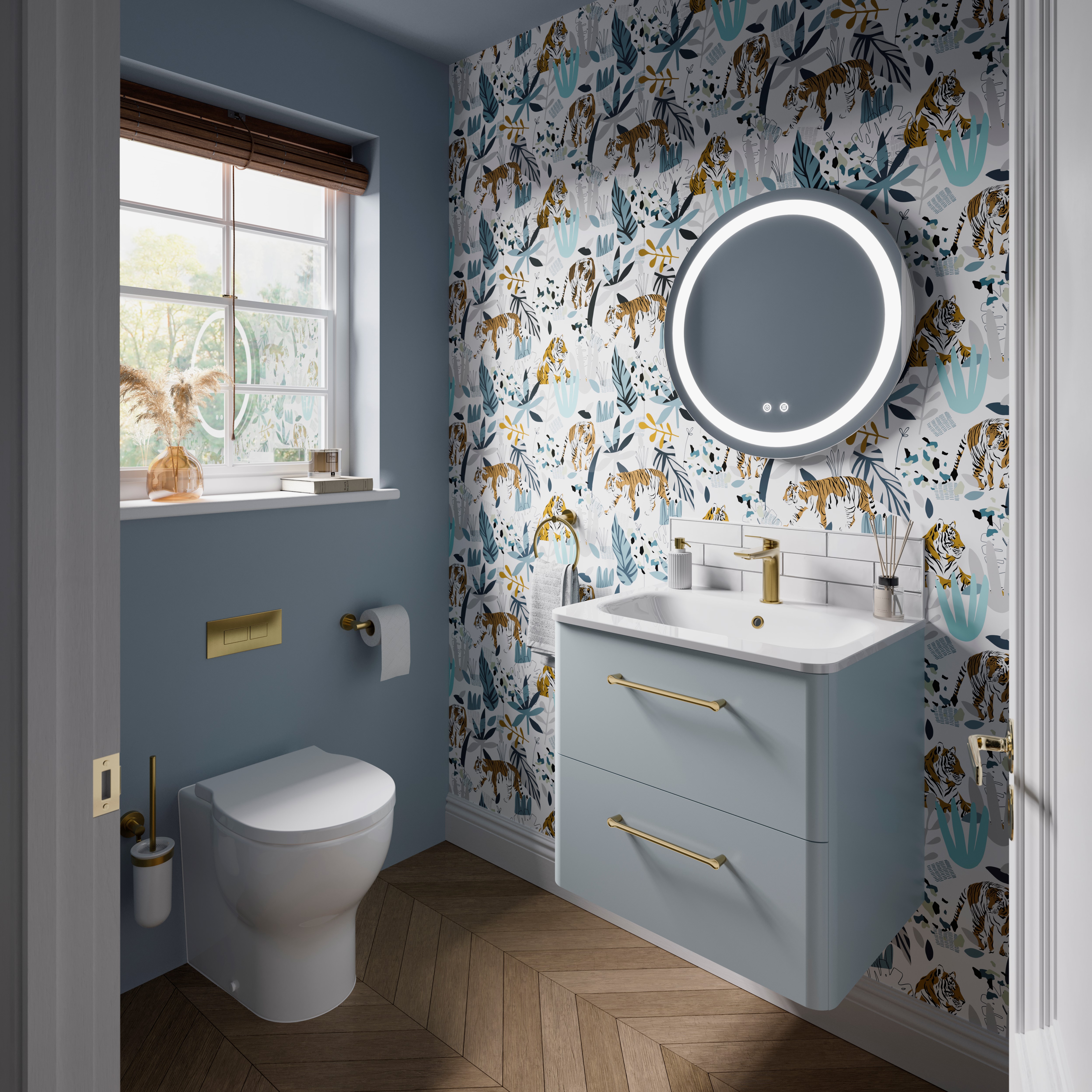 A tranquil and peaceful modern bathroom design using a light blue colour scheme. A nature inspired wallpaper helps to further the connections; a reminder of the natural environment and the positive energies that come with it. Camberwell Unit with Basin in Dusty Blue
