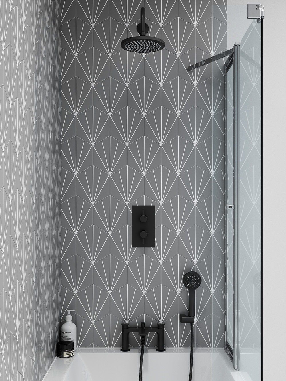 This shower set over a bath is backed with grey and white diamond patterned tiles. To compliment this colour scheme, matt black brassware has been used, including a showerhead, bath/shower mixer and shower valve. Hoxton Matt Black brassware in a monochrome bathroom design